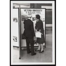Photograph from the Photographic Exhibition of two people looking at a  display