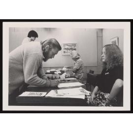 Person filling in a form at a desk