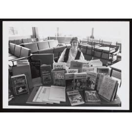 A woman sitting at VUW press table