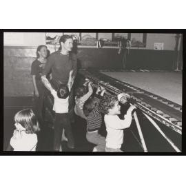 Women and children at the Childcare Centre with a trampoline