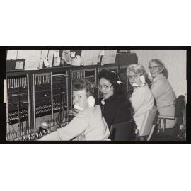 Four women at the telephone switchboard in the Robert Stout Building