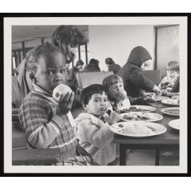 Young children eating at a table during the Civil Defence Welfare Exercise