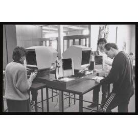 Students using the library microfiche readers