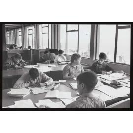 Students working at desks in the library