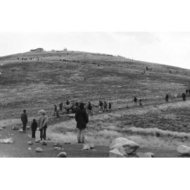 Looking up at Ōtehīwai Mt John observatory as demonstrators cover the road with rocks