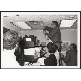 Nigel Isaacs, Michael Donn and John Gray, measuring air supply in a commercial building