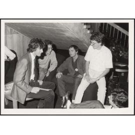 Group of people seated under a staircase at Beehive