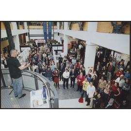 Person giving speech to crowd from balcony, 'Architecture Unleashed'