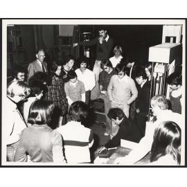 Student group observing demonstration of material strength