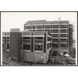 Cotton building under construction, with graffitti