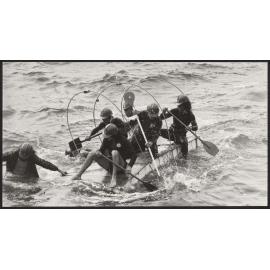 Students paddling raft in raft race