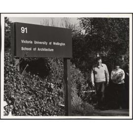 Two students walking up the path to the School of Architecture