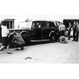 Students removing Governor General's car hubcaps 