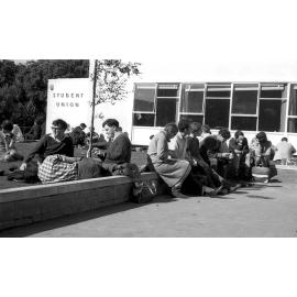 Students relaxing in the sun by Student Union