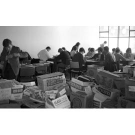 Students studying in new library surrounded by boxes of books