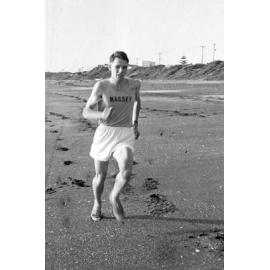 Massey University cross country runner on beach