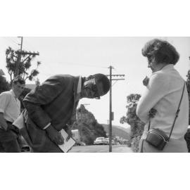 Musician Larry Gales [?] signs autograph 