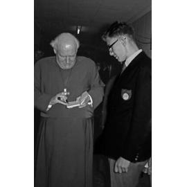 Canon Hugh Montefiore signing an autograph