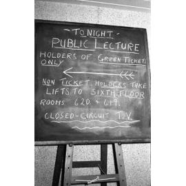 Chalkboard sign for closed-circuit viewing of Canon Hugh Montefiore's talk