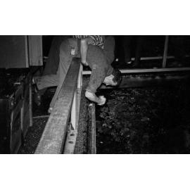 Student vomiting off the side of a balcony