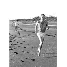 Weir House Warden Dr Tim Beaglehole running a cross-country race on the beach