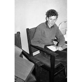 Student reading in bedroom at Weir House 