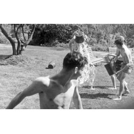 Weir House residents having a water fight on the front lawn