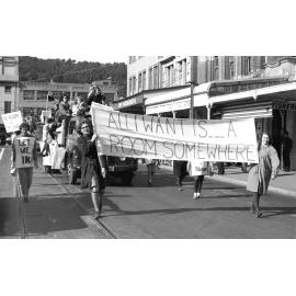 Students holding signs about housing in the annual student procession