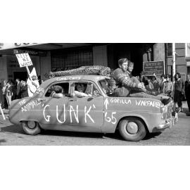 Students on top of Gunk '65 car at annual student procession through Wellington 
