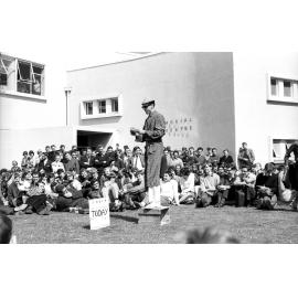 Speaker wearing dressing gown at the weekly student forum 
