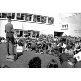 Students listening to a speaker on the soapbox at the weekly student forum